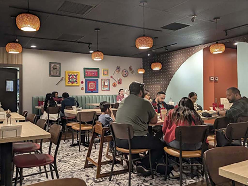 People dining in a cozy, colorful restaurant.